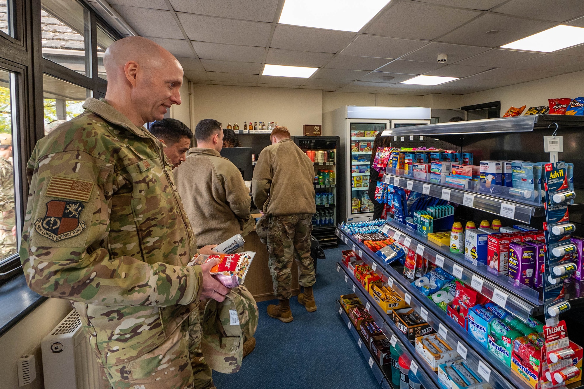 Airmen browse the shelves of the newly opened Mini-Mart