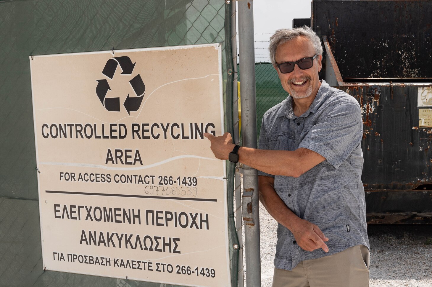Len Sinfield, manager of the environmental compliance program, Naval Support Activity Souda Bay, points to a controlled recycling area sign onboard NSA Souda Bay on April 17, 2024.