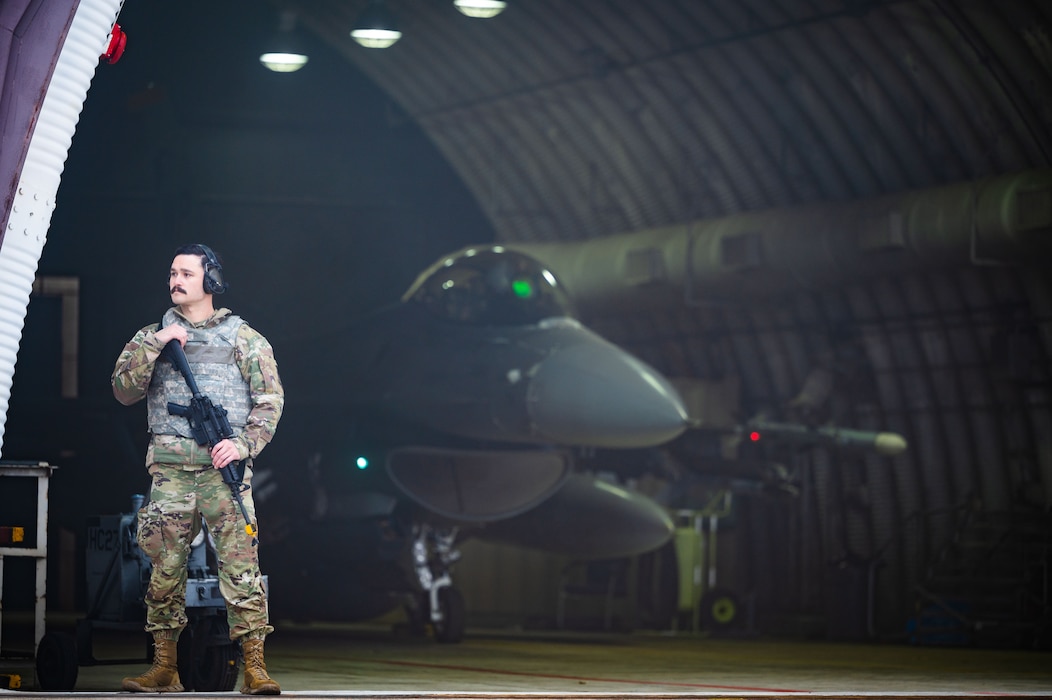 U.S. Air Force Staff Sgt. Justin Aaron, 80th Fighter Generation Squadron dedicated crew chief, provides armed guard surveillance
