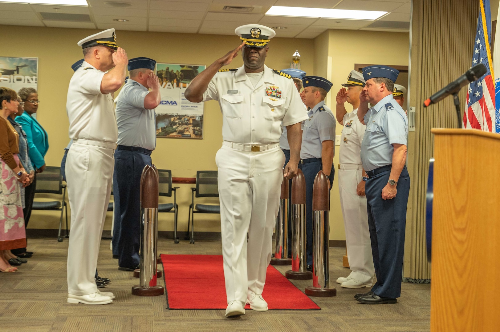 Man walks down middle of a line salute.