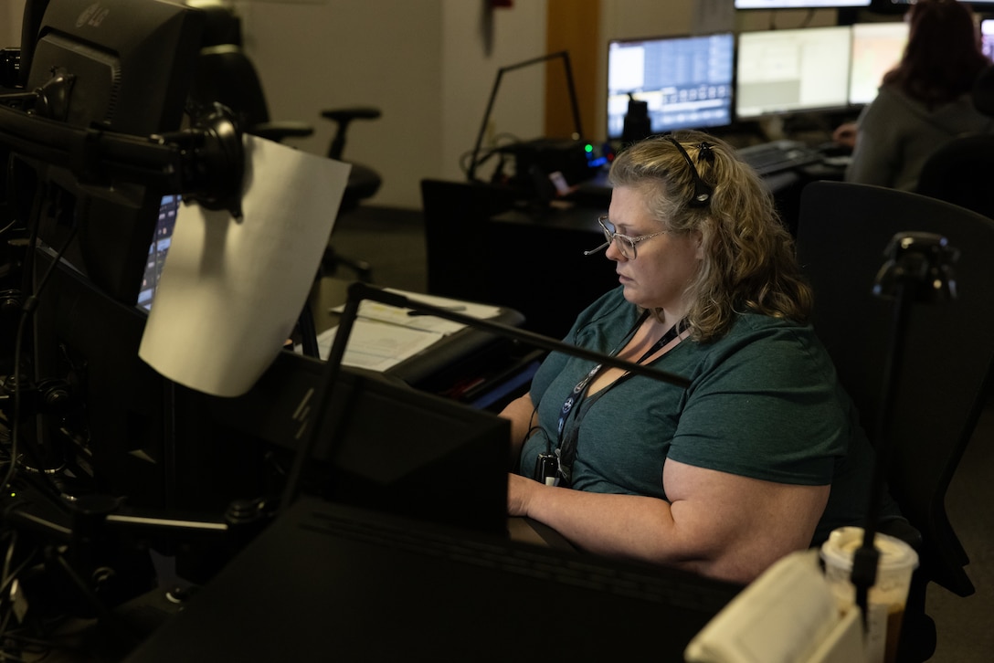 Amber Joesting, 911 dispatcher, Security Emergency Services, takes a call on Marine Corps Base Camp Lejeune, North Carolina, April 9, 2024. During the month of April, National Public Safety Telecommunicators Week is held to honor personnel in the public safety sector for their dedicated service to the community. (U.S. Marine Corps photo by Cpl. Jennifer E. Douds)