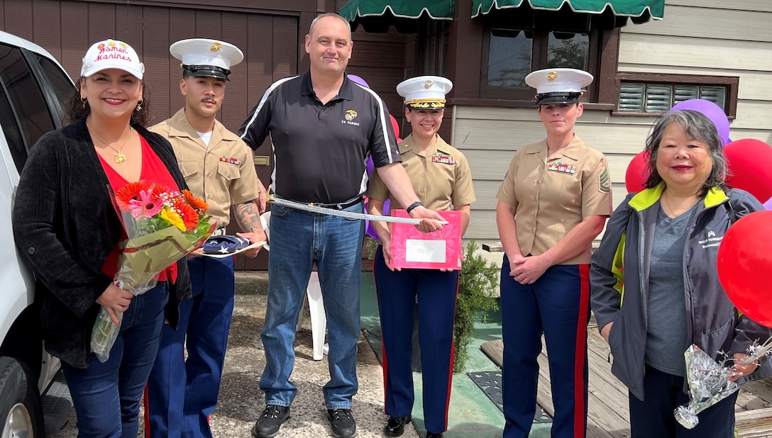 Friends and family pose for a photo with retired U.S. Marine Corps Corporal Lou 'Mama Lou' Keller on her 99th Birthday celebration March 30, 2024, in San Jose, CA. Mama Lou enlisted in the Marine Corps in honor of her WWI veteran father who passed away at age 50.