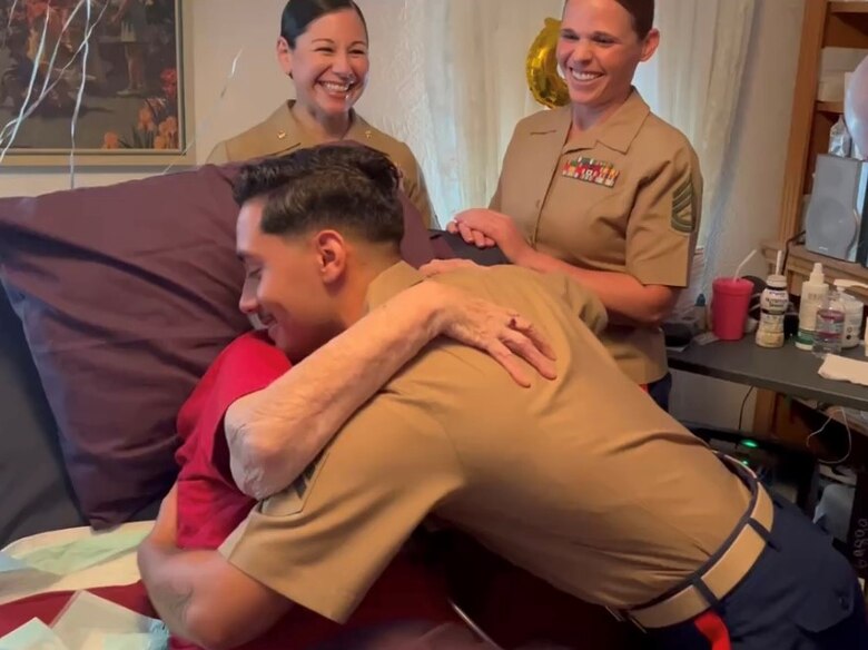 U.S. Marines with Headquarters Company, 23rd Marine Regiment, 4th Marine Division, exchange hugs with retired U.S. Marine Corps Corporal Lou 'Mama Lou' Keller during Mama Lou's 99th birthday celebration, March 30, 2024, in San Jose, CA. Mama Lou enlisted in the Marine Corps in honor of her WWI veteran father who passed away at age 50.