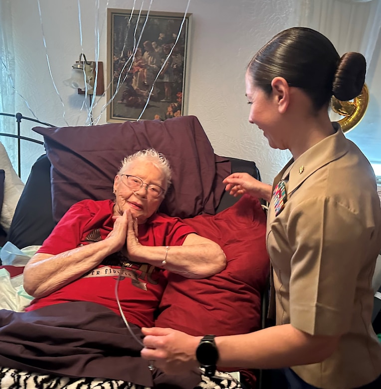U.S. Marine Corps Major Shannon Potts, A Manpower Officer assigned to Headquarters Company, 23rd Marine Regiment, 4th Marine Division hugs retired U.S. Marine Corps Corporal Lou 'Mama Lou' Keller at her 99th Birthday celebration, March 30, 2024, in San Jose, California. Mama Lou served two years in the Marine Corps during WWII processing Purple Hearts for Marines injured during the war.