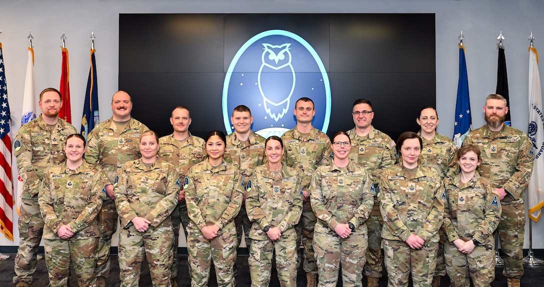 Vosler Academy cadre and staff pose for a group photo at Peterson Space Force Base, Colo., March 19, 2024. (Back row, left to right) Tech. Sgt. Robert Camblin, Master Sgt. Ryan Leader, Tech. Sgt. John Townsend, Master Sgt. Dalton Grainger, Master Sgt. Codey Chewning, Tech. Sgt. Kevin Nally, Tech. Sgt. Tarra Stott, Master Sgt. David Gallup (front row, left to right) Tech. Sgt. Macee Whitaker, Tech. Sgt. Victoria Meza, Airman 1st Class Christabelle Basto, Chief Master Sgt. April Brittain, Senior Master Sgt. Michele Brooks, Tech. Sgt. Jessica Morgan and Tech. Sgt. Erika D’Arcy (not pictured) Master Sgt. D’Ariel Banks, Tech Sgt. Tricia Viloria, and Tech. Sgt. Korina Dwyer. (U.S. Air Force photo by Capt. Charles Rivezzo)