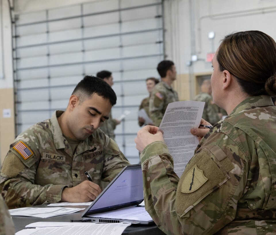 Spc. Jochell Palacio, processing pay at Final Formation on April 20th, 2024 at the Kentucky National Guard Boone Center ( U.S. Army National Guard photo by Staff Sgt. Lauren Kirk)