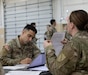 Spc. Jochell Palacio, processing pay at Final Formation on April 20th, 2024 at the Kentucky National Guard Boone Center ( U.S. Army National Guard photo by Staff Sgt. Lauren Kirk)