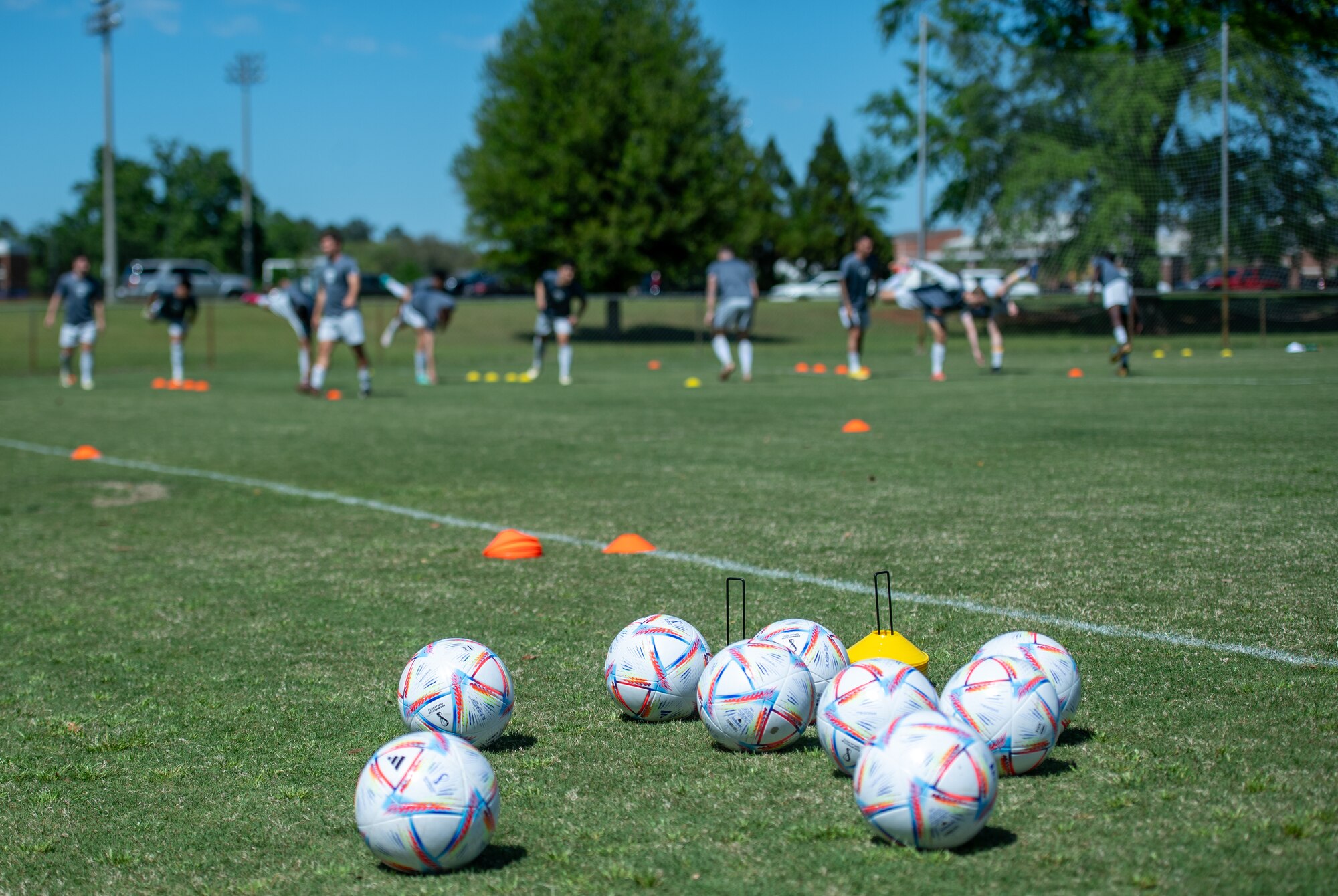 soccer balls lay i a field before a soccer game