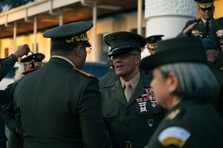U.S. Marine Corps Sgt. Maj. Rafael Rodriguez, the command senior enlisted leader of U.S. Southern Command, presents a coin to Minister of Defense Brigadier General Henry David Saenz.