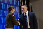 Army Brig. Gen. Gail Atkins shakes the hand of new acquisition executive Robert Johnson.