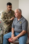 Maj. (Dr.) Avinash Chaurasia, radiation oncologist, examines Scott Anglin at Brooke Army Medical Center, Joint Base San Antonio-Fort Sam Houston, Texas, on April 17, 2024. Anglin, an Army veteran and cancer survivor, receives his follow-on care at BAMC. (DOD photo by Jason W. Edwards)