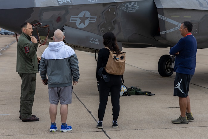 U.S. Marine Corps Maj. Adam Chase, a pilot with Marine Fighter Attack Training Squadron 502, Marine Aircraft Group 11, 3rd Marine Aircraft Wing, speaks with educators from Recruiting Stations Portland, Riverside, San Francisco, and Seattle during a static display as part of the 2024 Educator’s Workshop at Marine Corps Air Station Miramar, California, April 18, 2024. Participants of the workshop visit MCRD San Diego to observe recruit training and gain a better understanding about the transformation from recruits to United States Marines. Educators also received classes and briefs on the benefits that are provided to service members serving in the United States armed forces. (U.S. Marine Corps photo by Sgt. Jesse K. Carter-Powell)