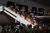 A photo of people deplaning a large jet.