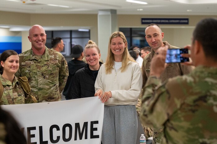 A photo of people posing for a picture.