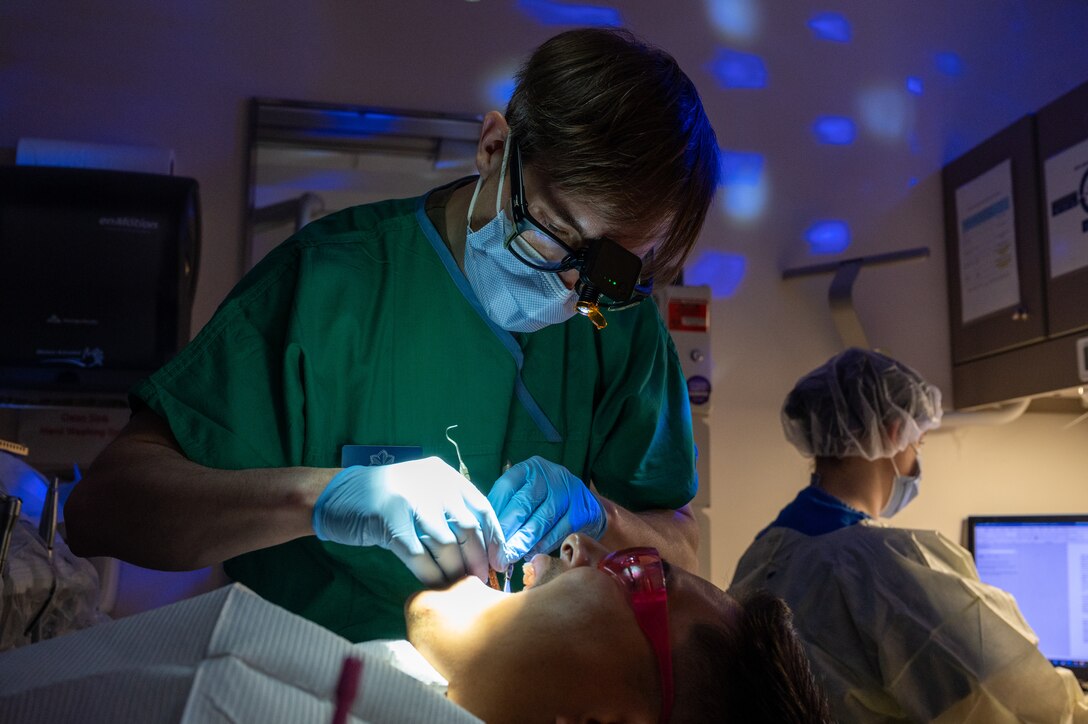 U.S. Air Force Lt. Col. Matthew Pastewait, 633d Dental Squadron orthodontist, examines his patient’s teeth at the dental clinic at Joint Base Langley-Eustis, Virginia, April 4, 2024. Dentists focus on diagnosis, treatment planning, and performing advanced dental procedures on patients to protect Airmen’s oral health. (U.S. Air Force photo by Airman 1st Class Skylar Ellis)