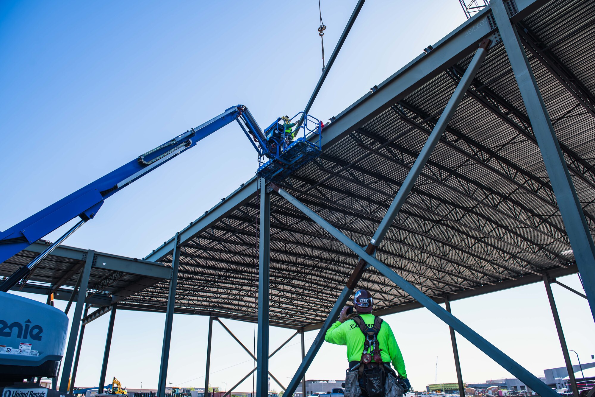 Contractors assigned to the civil engineer complex rebuild site weld steel on the roof of the 325th Civil Engineer Squadron maintenance facility