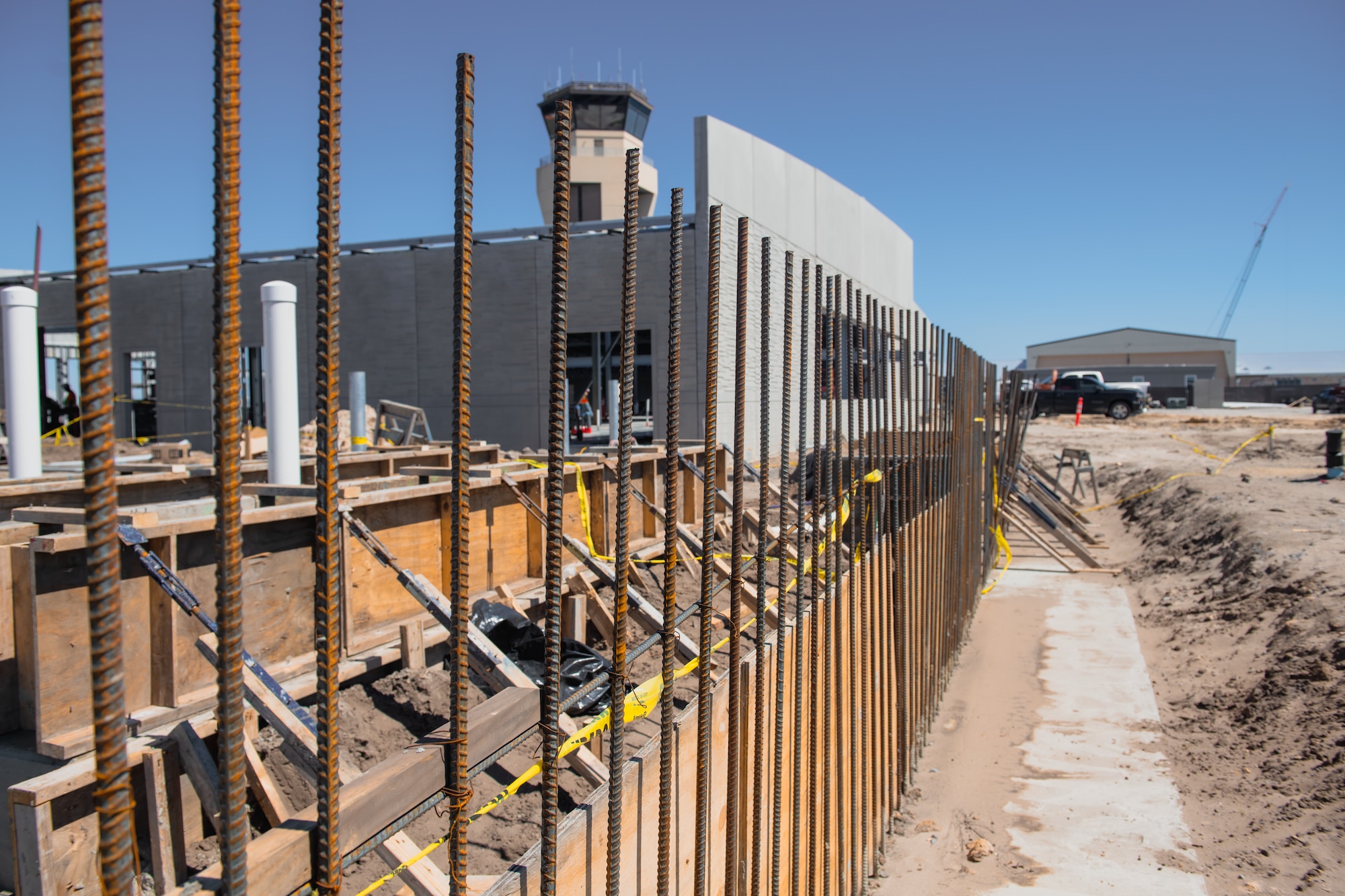 The cooling tower and generator pads are being installed at the site of the operations support squadron facility