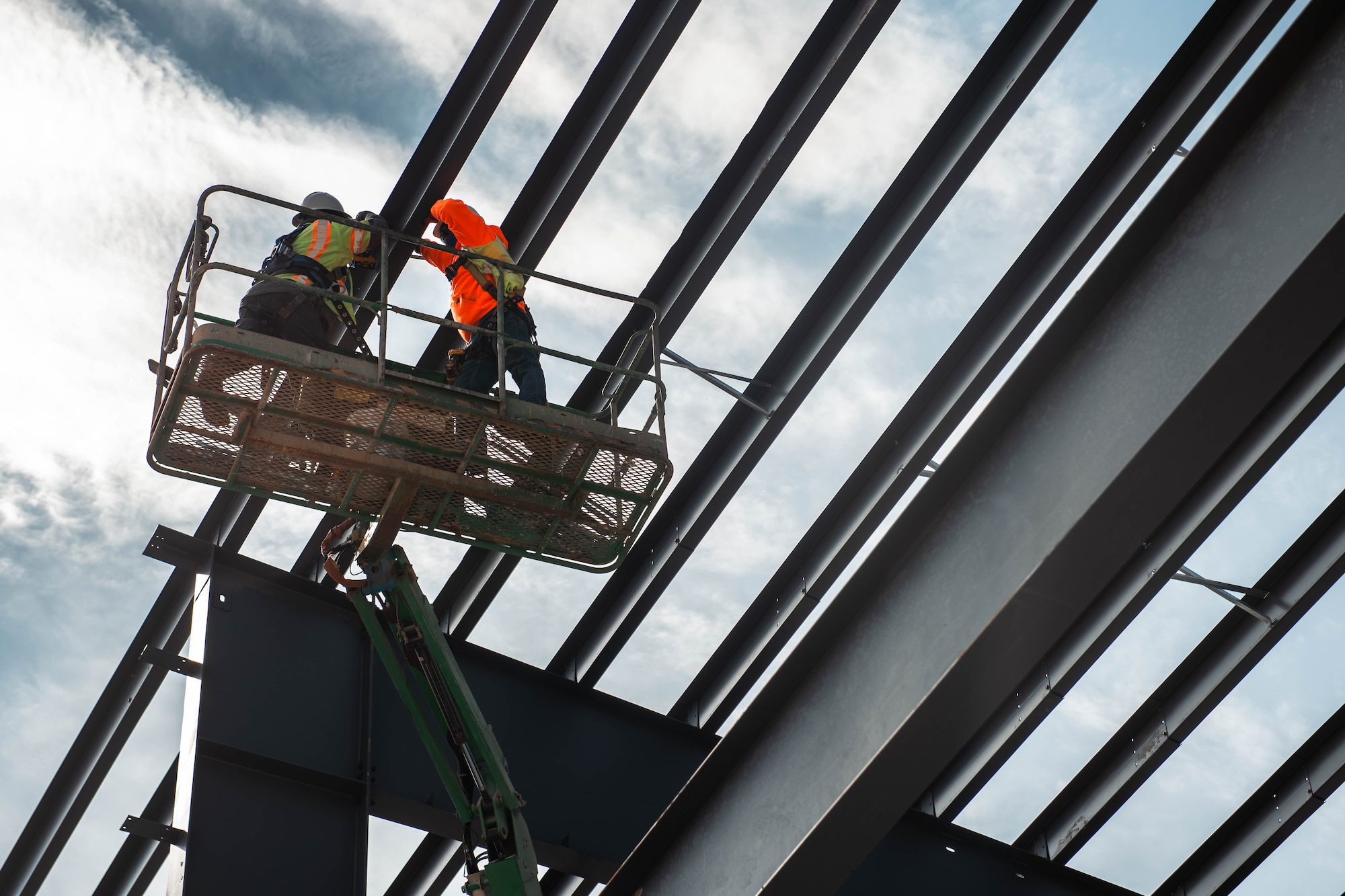 Contractors install cross braces on the roof of the new vehicle operations facility.