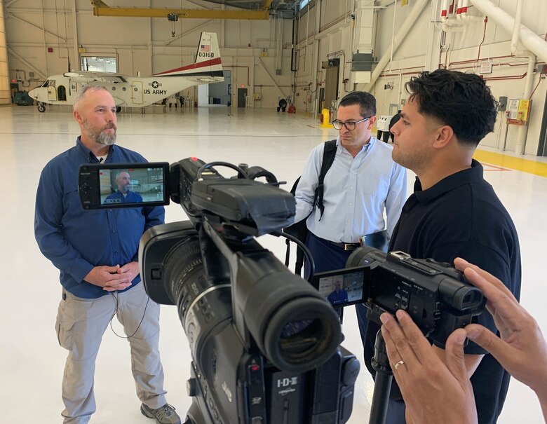 Jason Russell, a U.S. Army Corps of Engineers Los Angeles District project engineer, expresses the LA District's support for American troops during a media interview April 9 at Yuma Proving Ground in Arizona. LA District and Yuma Proving Ground military leaders celebrated the official completion of a facility for the U.S. Army Special Operations Aviation Command during a ribbon-cutting ceremony on the same day at the installation.