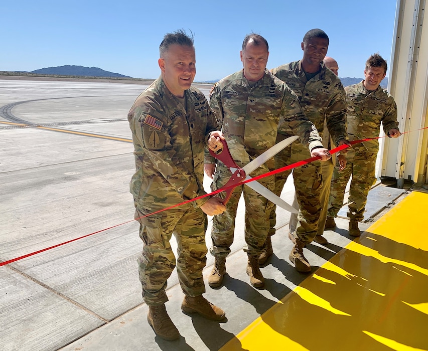 Lt. Col. Sean Karrels, battalion commander with the 160th Special Operations Aviation Regiment, left, cuts the ribbon on a two-bay hangar that will be used for training during an April 9 ribbon-cutting ceremony at Yuma Proving Ground, Arizona. The U.S. Army Corps of Engineers Los Angeles District constructed the hangar for the Special Operations Aviation Command flight detachment that supports training operations for the Military Freefall School.