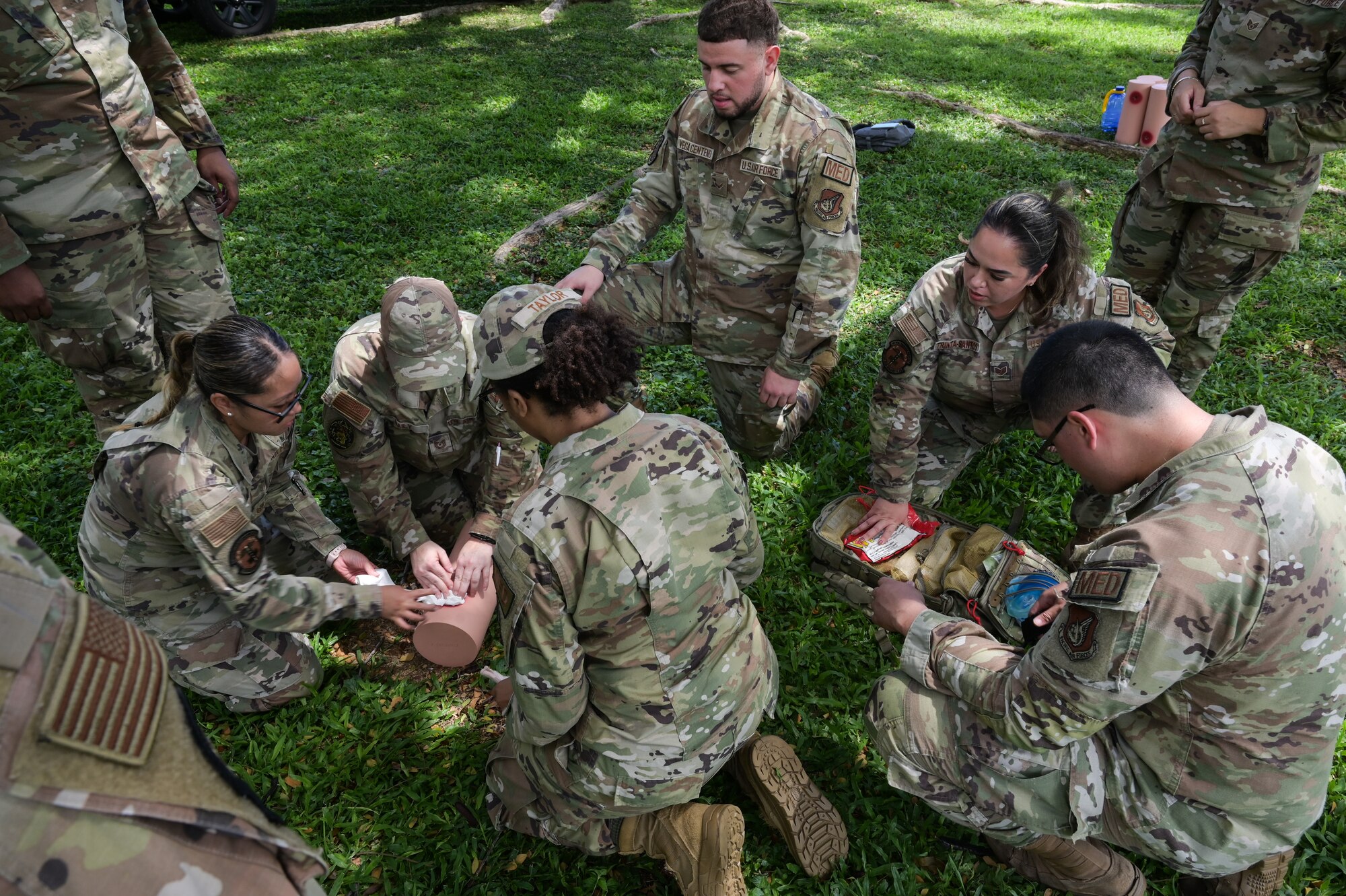 Airmen assigned to the 15th Medical Group pack a simulated wound during a Tactical Combat Casualty Care and Ability to Survive and Operate relay at Joint Base Pearl Harbor-Hickam, Hawaii, April 17, 2024. Eight teams participated in the relay, racing to see which team could accomplish each TCCC station correctly in a short time. (U.S. Air Force photo by Staff Sgt. Alan Ricker)