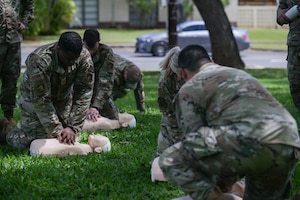 Airmen assigned to the 15th Medical Group perform cardiopulmonary resuscitation during a Tactical Combat Casualty Care and Ability to Survive and Operate relay at Joint Base Pearl Harbor-Hickam, Hawaii, April 17, 2024. The relay was part of a medical skills rodeo that tested the Airmen’s capabilities to perform effective trauma care during combat situations. (U.S. Air Force photo by Staff Sgt. Alan Ricker)