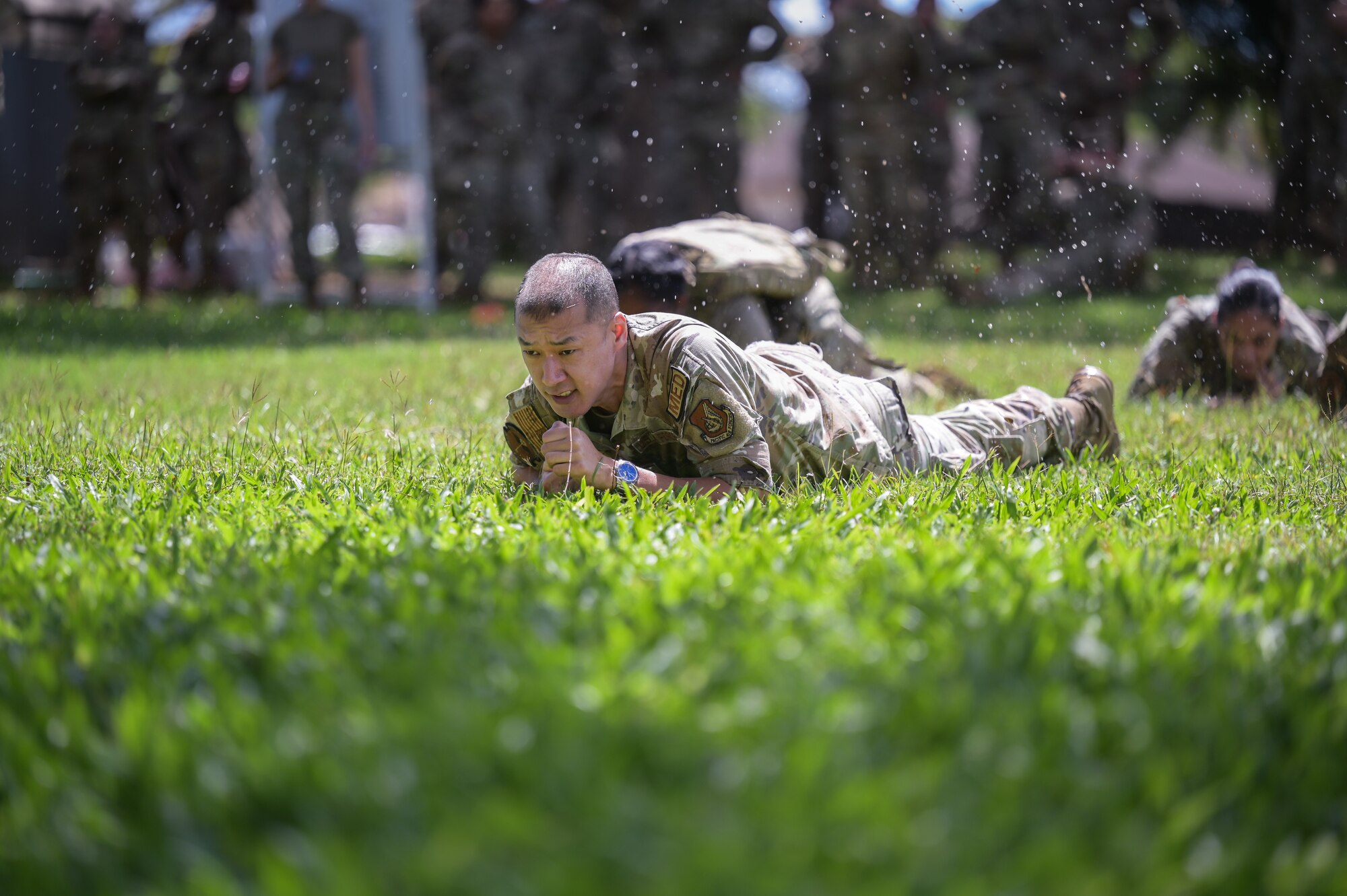 Airman performs low crawl during medical exercise.