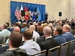 a large audience watching a speaker talk