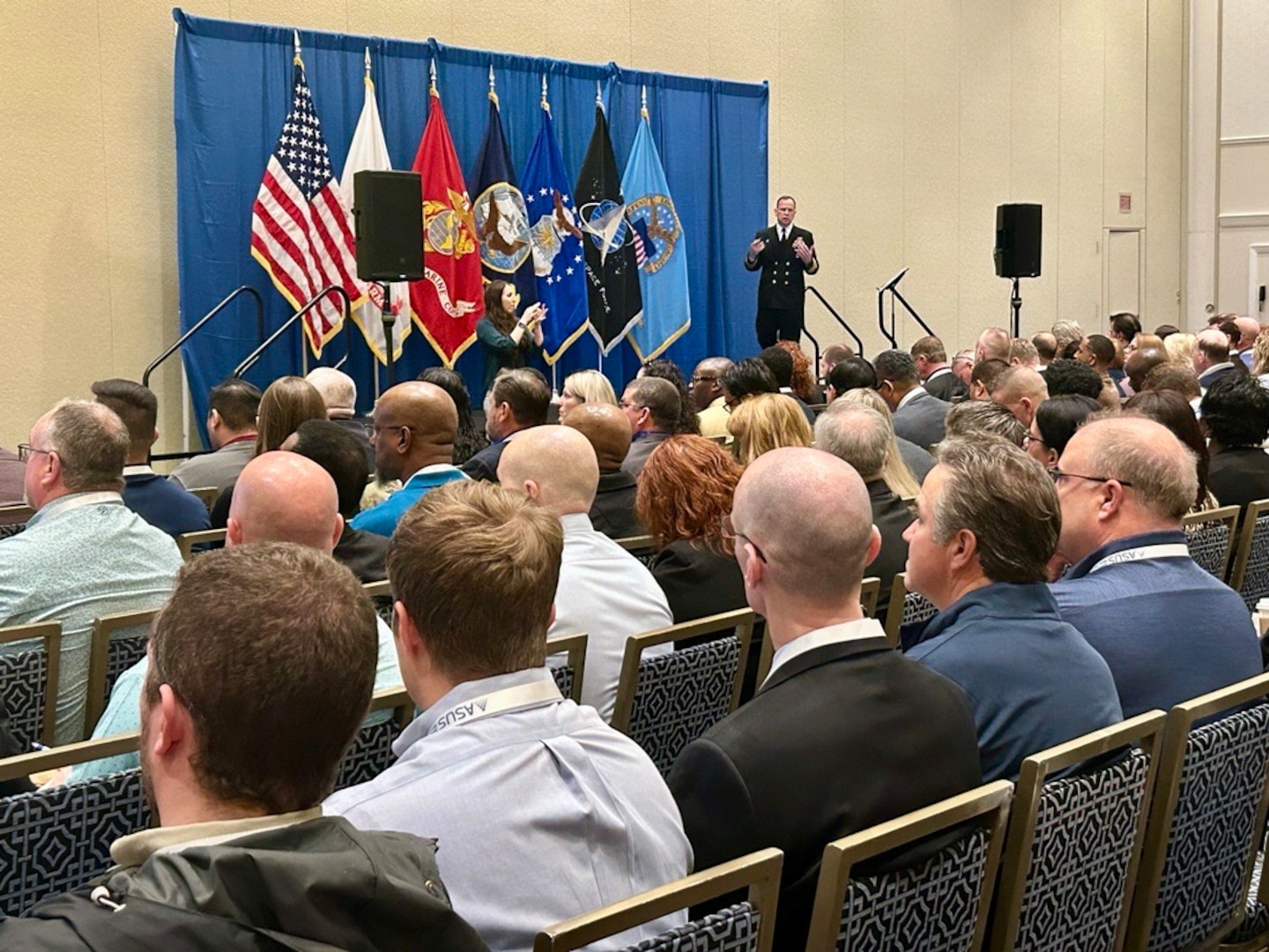 a large audience watching a speaker talk