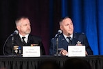 Two men in uniform speak on panel