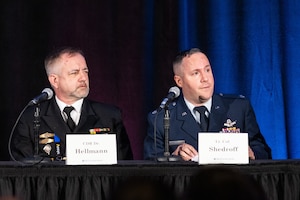 Two men in uniform speak on panel
