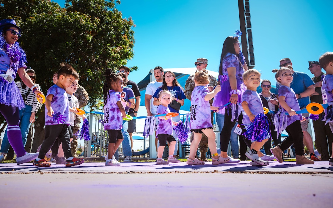 Children and caretakers from the Luke Air Force Base Child Development Center participate in a Purple Up parade.