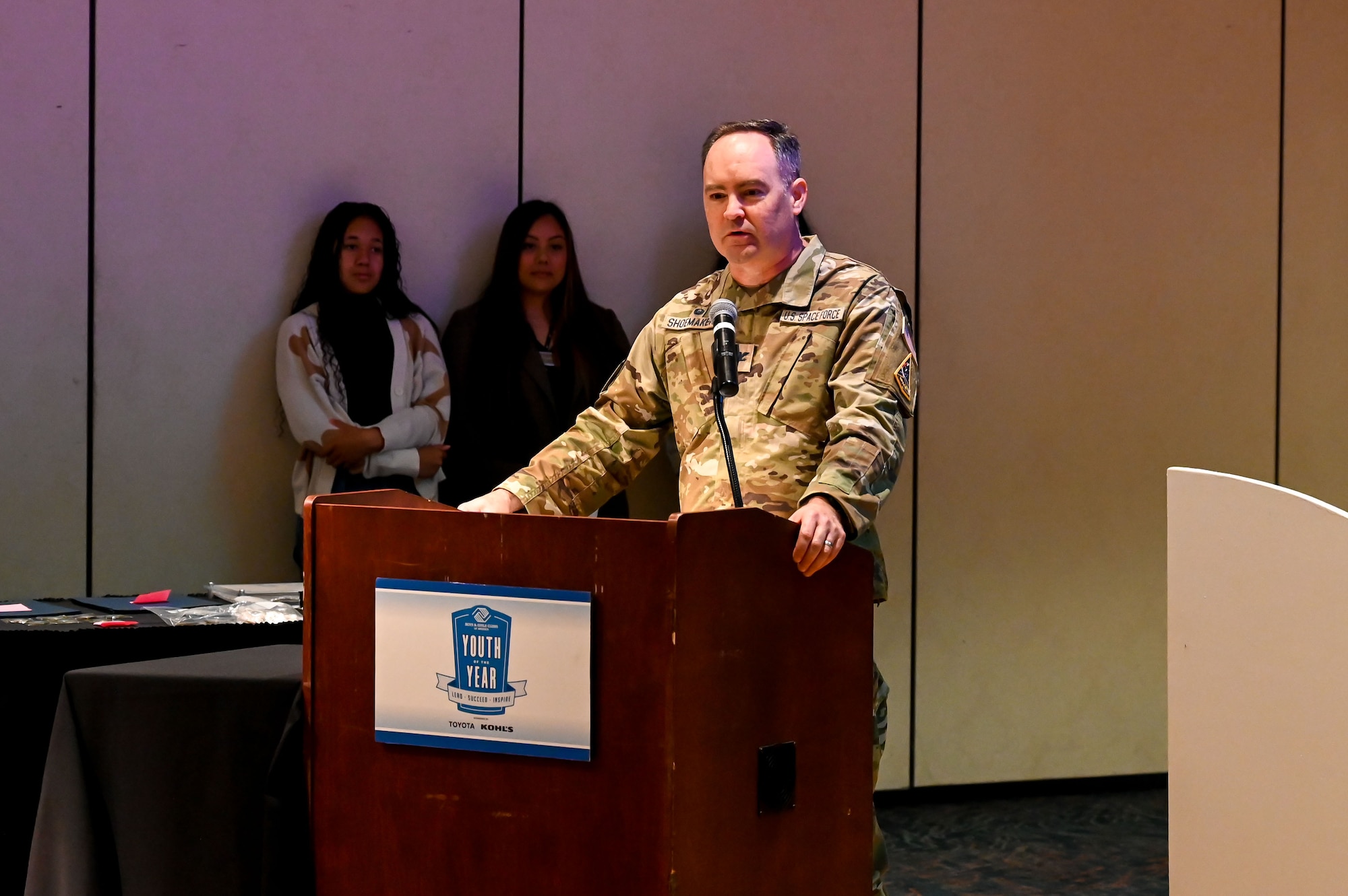 Col. Shoemaker delivers a speech at a podium.