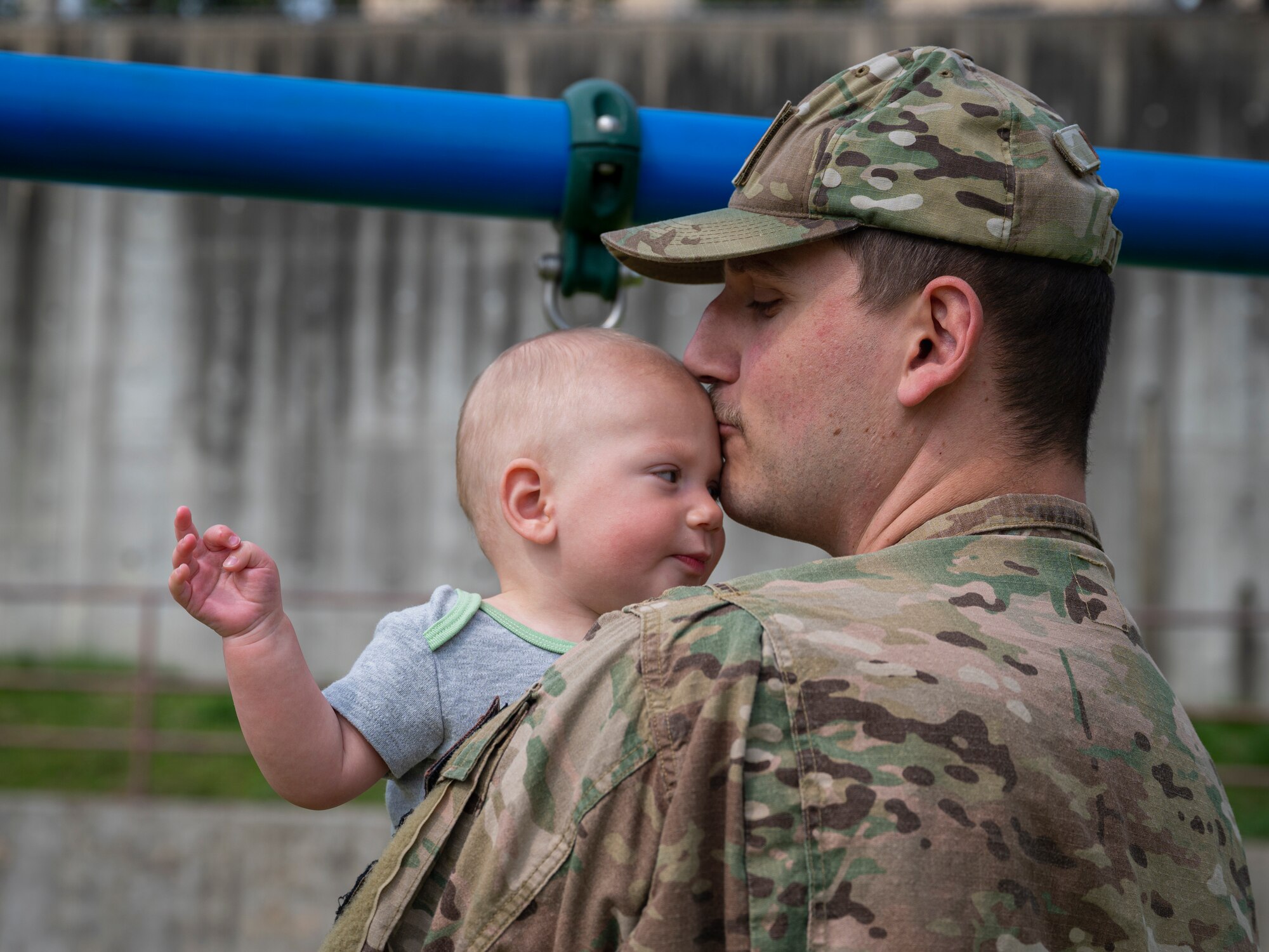 U.S. Air Force Capt. Justin Dollar, 51st Civil Engineer Squadron officer in charge of construction, embraces his son at Northlake Park, at Osan Air Base, Republic of Korea, April 10, 2024. The new playground is a safe space where Airmen can enjoy spending time with their families. (U.S. Air Force photo by Senior Airman Sabrina Fuller-Judd)