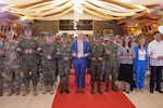 Philippine and U.S. government and military representatives conduct the “friendship way” handhold at the opening ceremony to commence Balikatan 24 at Camp Aguinaldo, Manila, Philippines, April 22, 2024. BK 24 is an annual exercise between the Armed Forces of the Philippines and the U.S. military designed to strengthen bilateral interoperability, capabilities, trust, and cooperation built over decades of shared experiences (U.S. Marine Corps Lance Cpl. Erica Stanke)