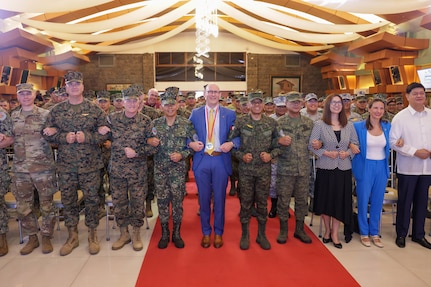 Philippine and U.S. government and military representatives conduct the “friendship way” handhold at the opening ceremony to commence Balikatan 24 at Camp Aguinaldo, Manila, Philippines, April 22, 2024. BK 24 is an annual exercise between the Armed Forces of the Philippines and the U.S. military designed to strengthen bilateral interoperability, capabilities, trust, and cooperation built over decades of shared experiences (U.S. Marine Corps Lance Cpl. Erica Stanke)