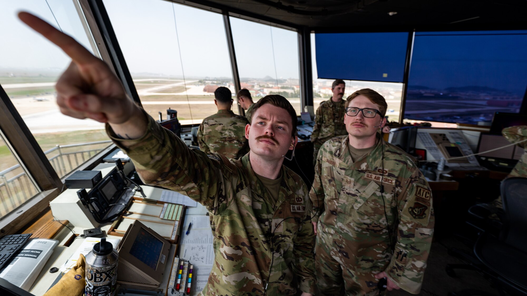 Staff Sgt. Brien Dye informs Tech. Sgt. Ryan Sanders on possible airspace obstacles.