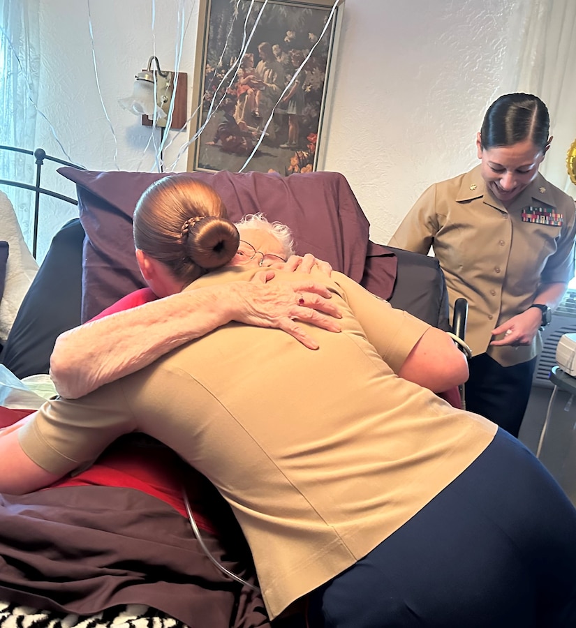 U.S. Marine Corps Gunnery Sgt. Kristina Perieff, assigned to Headquarters Company, 23rd Marine Regiment, 4th Marine Division, hugs retired U.S. Marine Corps Corporal Lou 'Mama Lou' Keller during Mama Lou's 99th Birthday Celebration, March 30, 2024, in San Jose, CA. Mama Lou served in the Marine Corps during WWII and strives to continue to encourage the next generation of Marines.