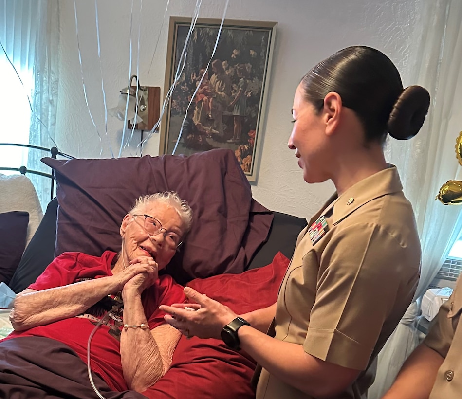 U.S. Marine Corps Major Shannon Potts, a Manpower Officer assigned to Headquarters Company, 23rd Marine Regiment, 4th Marine Division thanks retired U.S. Marine Corps Corporal Lou 'Mama Lou' Keller for her years of service, March 30, 2024, in San Jose, CA. Mama Lou enlisted in the Marine Corps in honor of her WWI veteran father who passed away at age 50.