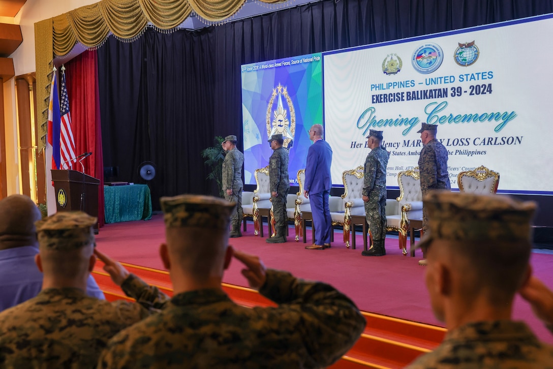 U.S. military service members stand and salute for the Philippine and U.S. national anthems during the Exercise Balikatan 24 opening ceremony at Camp Aguinaldo, Manila, Philippines, April 22, 2024. BK 24 is an annual exercise between the Armed Forces of the Philippines and the U.S. military designed to strengthen bilateral interoperability, capabilities, trust, and cooperation built over decades of shared experiences. (U.S. Marine Corps photo by Lance Cpl. Erica Stanke)