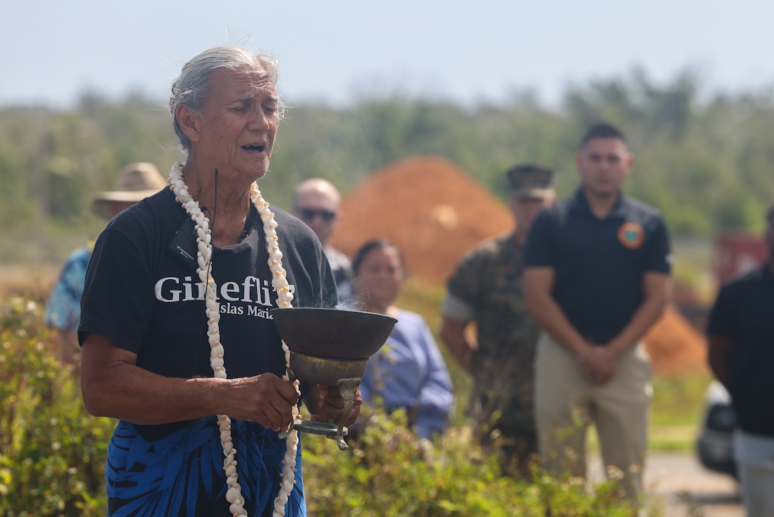 Toni ‘Malia’ Ramirez, Guam historian, performs a CHamoru ritual at Sabånan Fadang on Marine Corps Base (MCB) Camp Blaz, April 5, 2024. The Guam State Historic Preservation Office hosted a reinterment ritual aboard MCB Camp Blaz for the reinterment of ancestral bone fragments found during cultural resource investigations in Sabånan Fadang. During the construction of the Blaz main cantonment, archeologists discovered five sites each with at least one burial dating to the Latte Period. All CHamoru burials at Sabånan Fadang were preserved in place. The bone fragments, discovered outside of a burial context, were wrapped in muslin and placed in woven baskets before being reinterred amongst the burials. (Marine Corps photo by Lance Cpl. Ryan Little)