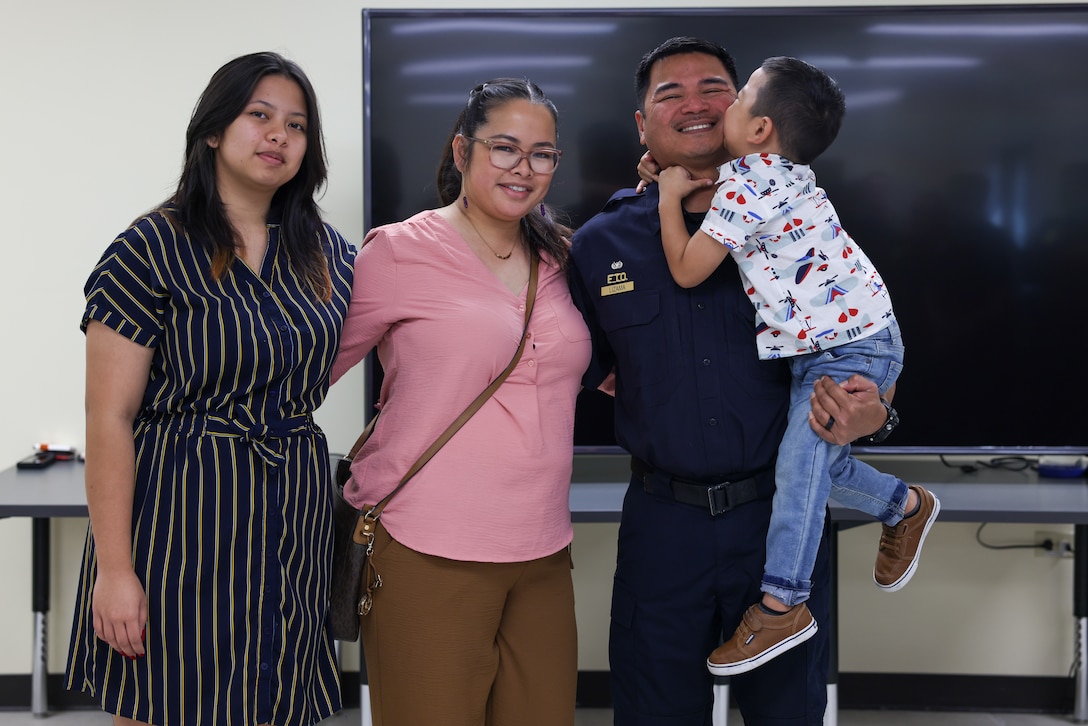 Maj. John R. Lizama, newly promoted supervisory police officer with Marine Corps Base Camp Blaz, poses with family after his promotion to the rank of major on Naval Computer and Telecommunications Station, Guam, Feb. 27, 2024. Maj. Lizama was promoted due to his exemplary performance of maintaining and applying advanced knowledge of law enforcement, physical security, and anti-terrorism to ensure the operations section of the provost marshal office is always ready to respond. (U.S. Marine Corps photo by Lance Cpl. Ryan Little)