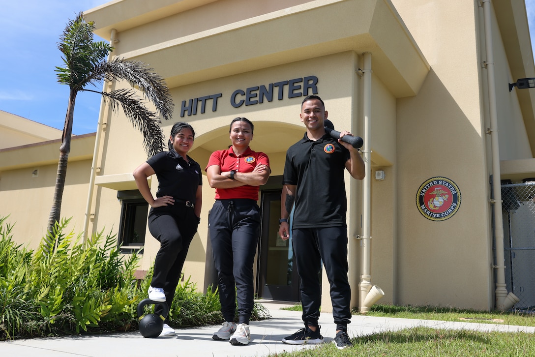 From left to right, Marine Corps Base (MCB) Camp Blaz staff Leanah Oledan, a recreation assistant, Raelene Tajalle, the Marine Corps Community Services semper fit director, and Brandon Salas, a recreation assistant, pose in front of MCB Camp Blaz’s High Intensity Tactical Training center located on Andersen Air Force Base, Guam, April 15, 2024. MCB Camp Blaz is focusing on the health and readiness of the Marines and Sailors, setting the standards for future units to come. (Marine Corps photo by Lance Cpl. Ryan Little)
