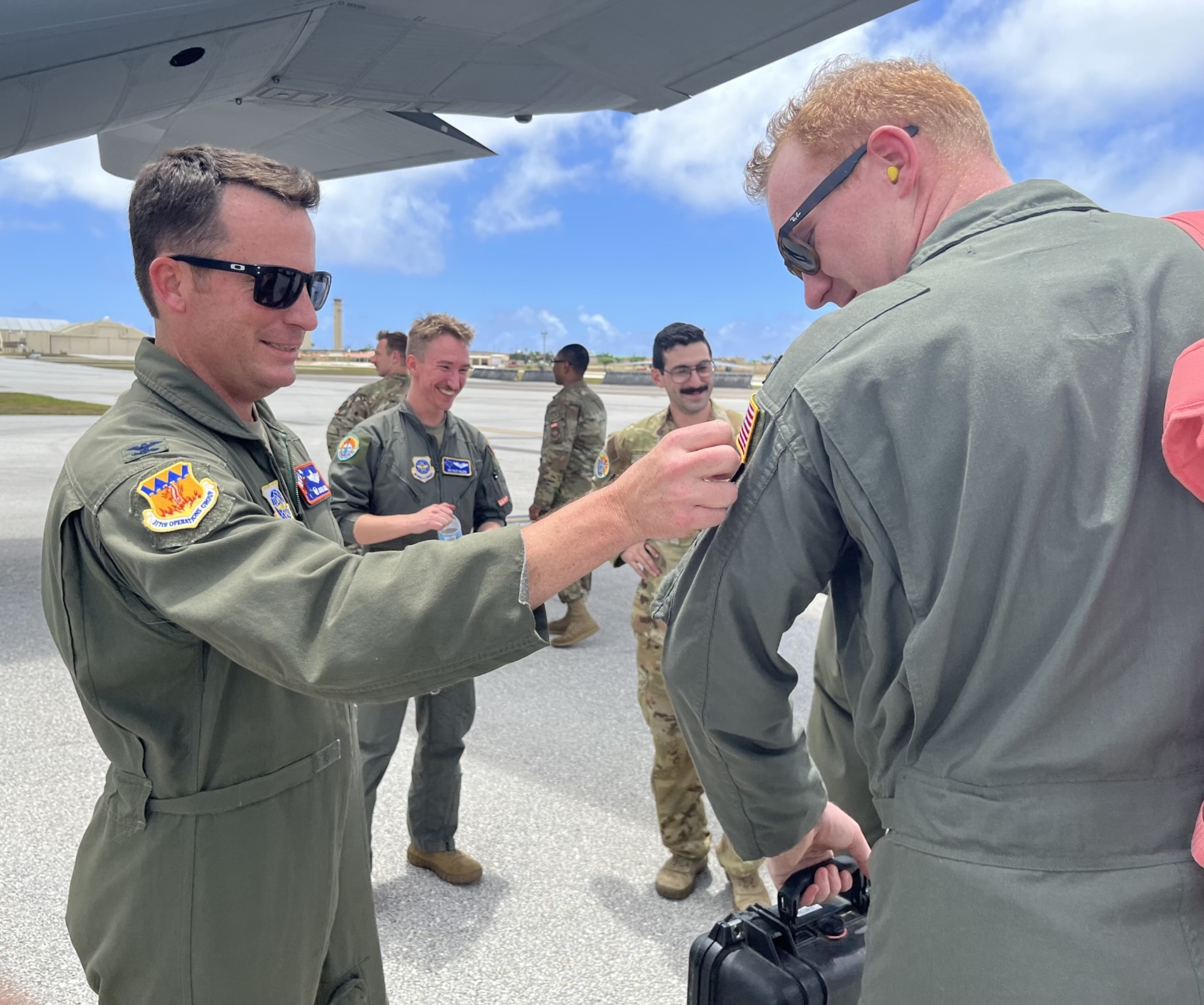The 317th Operations Group Commander gives out Hazard Leap patches to the flight crew.