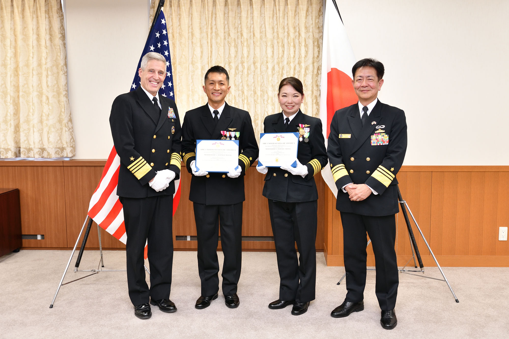 Adm. Stephen Koehler, commander, U.S. Pacific Fleet, center left, and Vice Adm. Akira Saito, the commander in chief of the Self-Defense Fleet, Japan Maritime Self-Defense Force, right, pose for a photo with recipients of the Meritorious Service Medal in Yokosuka, Japan, April 16, 2024. (Photo Courtesy of U.S. Navy)