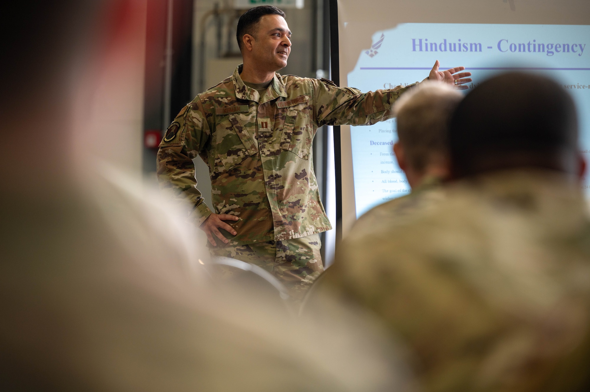 U.S. Air Force Capt. Vikas Kumar, 86th Operations Support Squadron aerospace physiologist, presents slides on Hinduism during a joint religious support team training