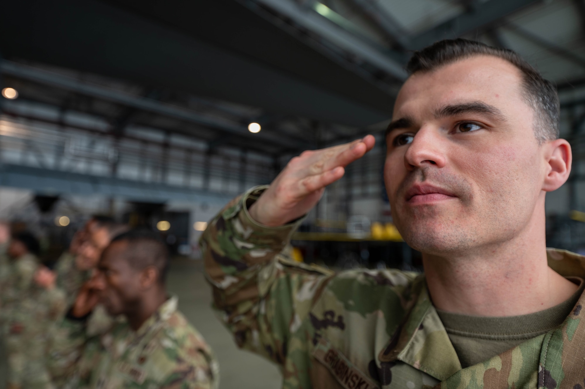 U.S. Air Force Tech. Sgt. James Grabinski, 86th Airlift Wing Headquarters Chapel noncommissioned officer in charge of chapel operations, renders a salute during a ramp ceremony training
