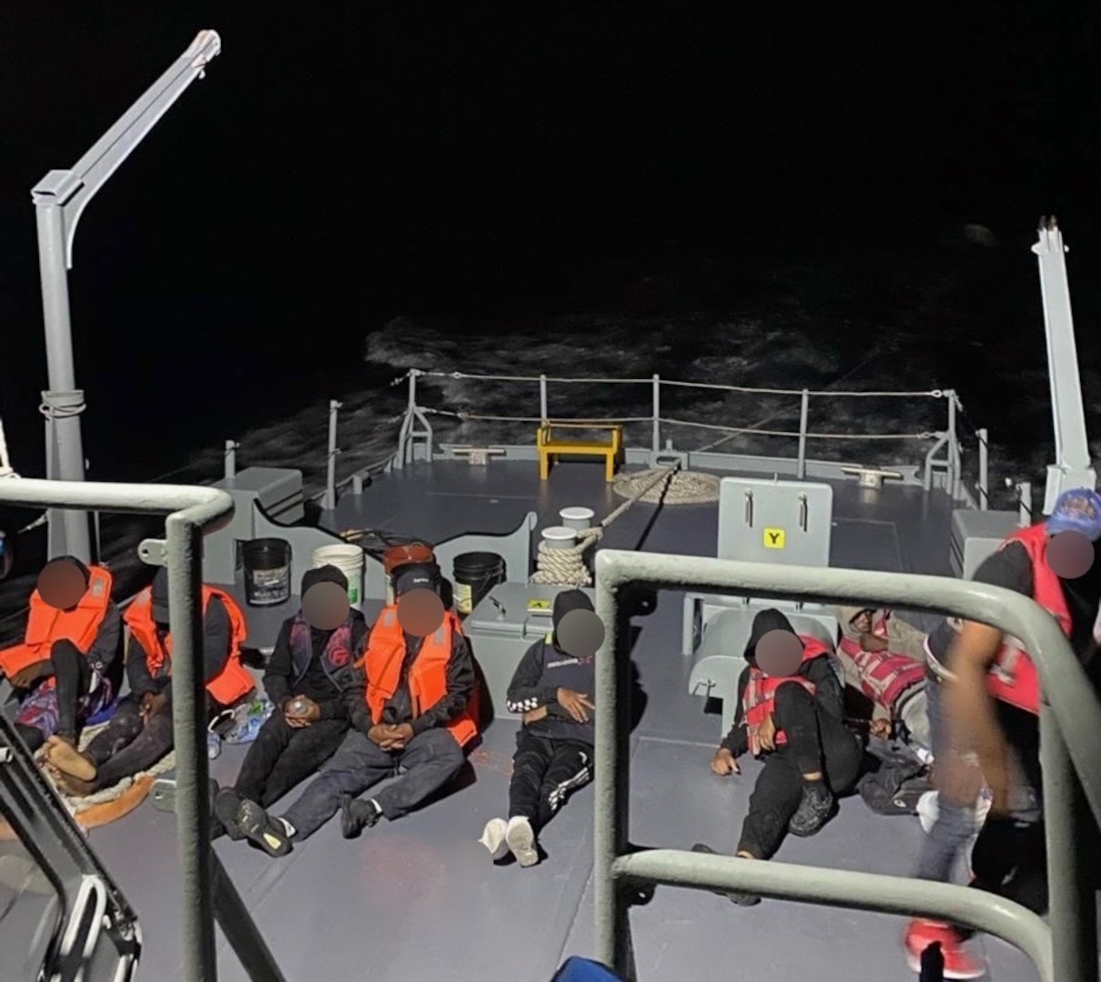 Photo of eight persons aboard a Dominican Republic Navy vessel after they were interdicted by the Coast Guard Cutter Winslow Griesser during an unlawful maritime migration voyage in the Mona Passage, April 19, 2024. Following the interdiction, Dominican Republic Navy authorities detained three U.S. citizens from this voyage, who reportedly are wanted in connection with a July 2020 shooting at a residential community in Puerto Rico, where four people were killed. U.S. Marshals Service authorities are coordinating the extradition of the three suspects to the U.S. territory of Puerto Rico. (Courtesy Photo)