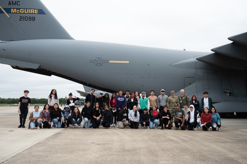 Students pose for a photo in front of a C-17 Globemaster III during the Student Engagement and Career Day event at Joint Base McGuire-Dix-Lakehurst, N.J., April 19, 2024. The event is meant to inspire and motivate the next generation of future service members through a positive and lasting impact. (U.S. Air Force photo by Airman 1st Class Aidan Thompson)
