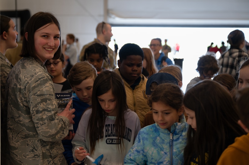 A Civil Air Patrol member speaks to students during the Student Engagement and Career Day event with one of the volunteers at Joint Base McGuire-Dix-Lakehurst, N.J., April 19, 2024. The event is meant to inspire and motivate the next generation of future service members through a positive and lasting impact. (U.S. Air Force photo by Airman 1st Class Aidan Thompson)